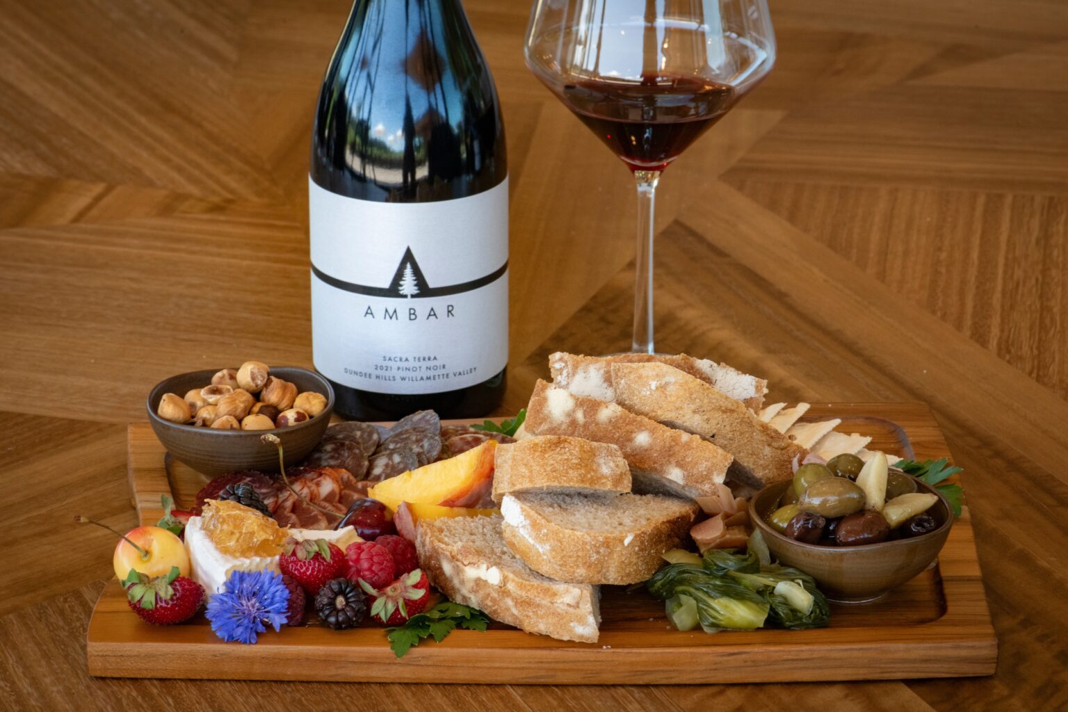 Pinot Noir bottle & glass with charcuterie & cheese board